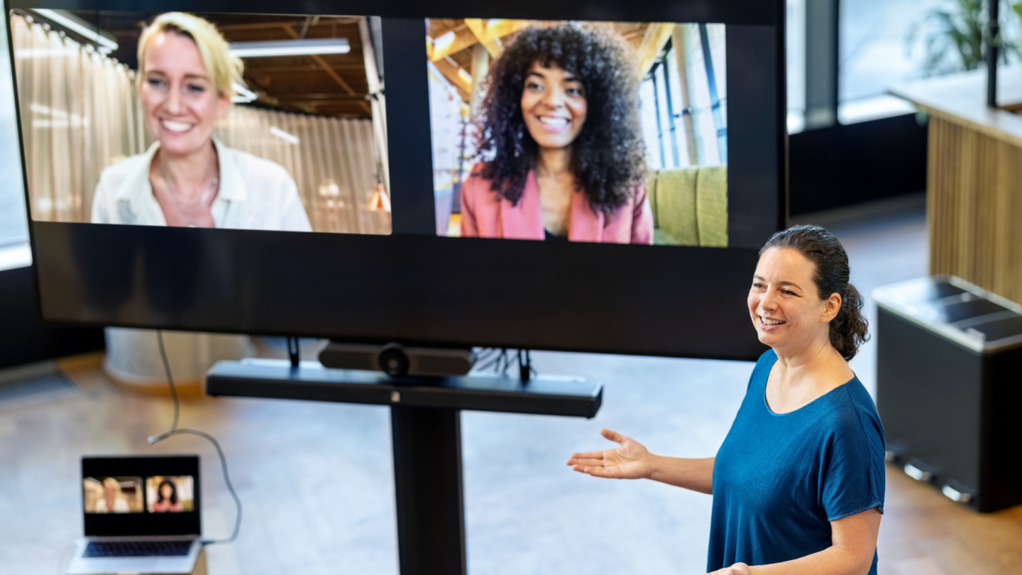 Hybrid employees conferencing in on screen